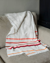 Load image into Gallery viewer, Handmade cotton orange and pink blanket laid on sofa