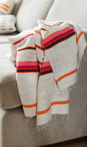 Handmade cotton orange and pink blanket on sofa