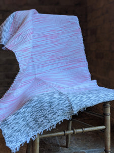 Handmade handwoven cotton pink grey pattern rug over chair