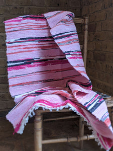 Handmade handwoven pink pattern rug on a chair