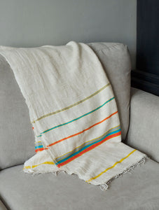 Handmade multicoloured cotton blanket on sofa