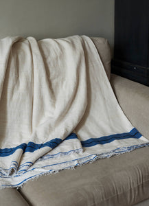 Handmade cotton white and blue blanket throw on a sofa