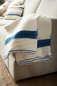 Handmade white and blue cotton blanket throw on a sofa