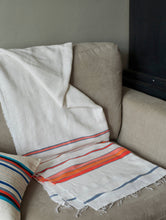 Load image into Gallery viewer, Handmade white orange and blue cotton throw blanket on a sofa