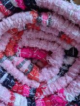 Load image into Gallery viewer, Rolled up close up of handmade handwoven pink pattern rug